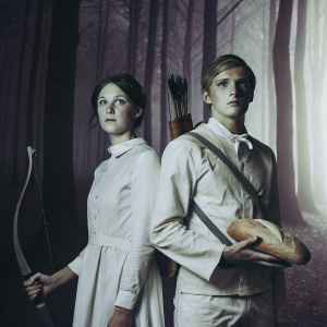 Fan art depicting Katniss Everdeen and Peeta Mellark in a dark forest scene, with a melancholic atmosphere.