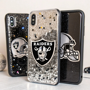 Close-up shot of iPhone cases. Sparkling confetti design. Oakland Raiders logo prominently featured. Black and silver glitter, helmet and 'RAIDERS' word. Textured surface. Product photo
