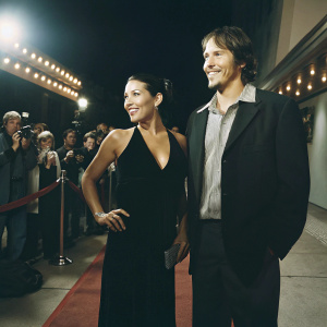 Emily Rios and Sergio Peris-Mencheta at the premiere of 'Snowfall'. Black dress and sleek bun for Emily. Red carpet ambiance.