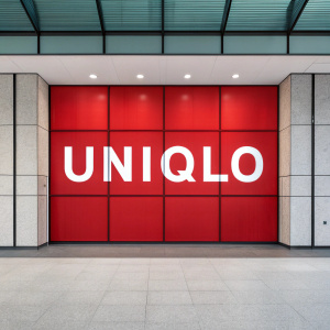 Modern flat design featuring a bold UNIQLO logo. White text on a vibrant red background.