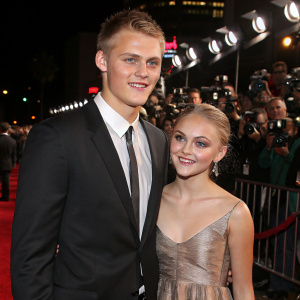 Alexander Ludwig and AnnaSophia Robb, attending the premiere of their latest film. Crowded red carpet with flashing cameras and paparazzi