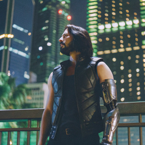 Johnny Silverhand, from the game Cyberpunk 2077, standing in a futuristic cityscape. Dark hair, beard, and a metallic arm. Wearing a sleek black leather vest.