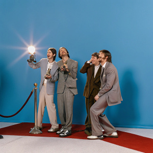 Red carpet at Grammy Awards. Anthony Kiedis, John Frusciante, Flea, and Chad Smith. Dressed in tuxedos, celebrating with awards