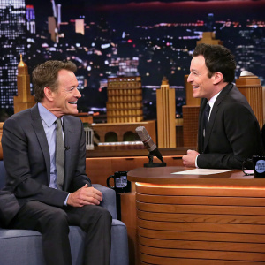 Jimmy Fallon interviewing Bryan Cranston on 'The Tonight Show'. Studio audience in the background