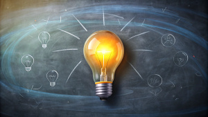 Education concept image. Creative idea and innovation. Light bulb as metaphor over blackboard