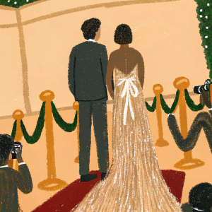Jonathan Tucker, in a dark suit, and Tara Ahamed Tucker, in a sparkling gown, stand out at the awards show gala. Red carpet, paparazzi in the background