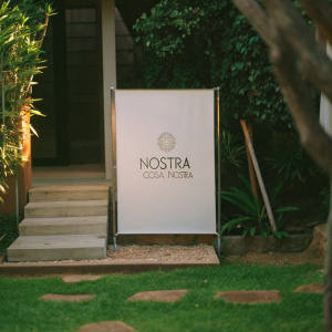 The Nostra Cosa Nostra logo displayed on a sleek, modern white backdrop.