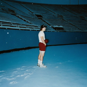 Blaine Gabbert, quarterback, dressed in casual wear: white t-shirt, red shorts, and cap. Training session at a snowy stadium.