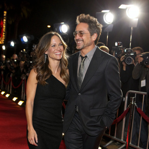 Robert Downey Jr and Susan Downey at a film premiere. Red carpet event, flashing cameras