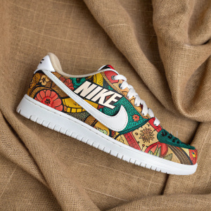 Creative Nike logo design on a rustic brown fabric. Vibrant colors and playful patterns blend into an artistic masterpiece. The logo stands prominently at the center, showcasing a fresh and innovative look.