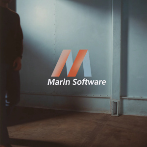 The Marin Software logo redesign. A sleek, modern 'M' in vibrant orange and green on a stark white backdrop.