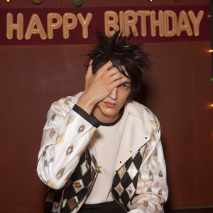 Jonathan Joestar, from JoJo's Bizarre Adventure, with a hand over his face, looking contemplative. Happy Birthday message at the top on a vibrant green backdrop.