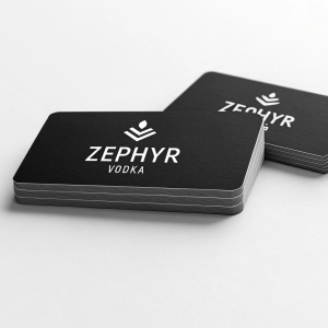 Modern minimalist design for business cards. Zephyr Vodka logo in white text on a black background. Business cards neatly arranged in a row.