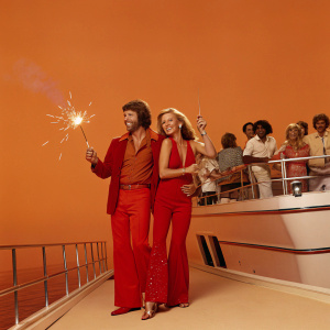 Bert Convy, Cheryl Ladd, and Bo Hopkins at a yacht party. Luxurious yacht with crowd in background.
