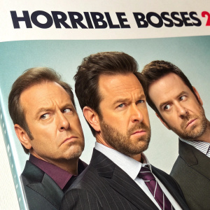 DVD cover of Horrible Bosses 2. Three men in suits. Title in bold at top. Provides movie format and content information.