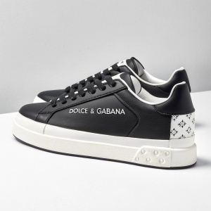 Stylish black and white sneakers from Dolce & Gabbana, featuring minimalist design and logo branding. Product shot on plain white surface.