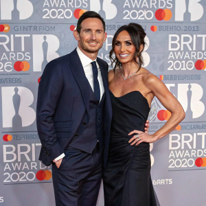 Frank Lampard and Christine Lampard at the Brit Awards, posing for pictures. Sparkling backdrop with multiple award logos