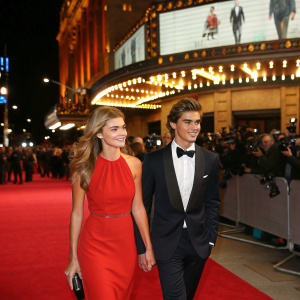 Indiana Evans and Brenton Thwaites at the premier of a blockbuster movie. Dressed in formal attire. Red carpet event.