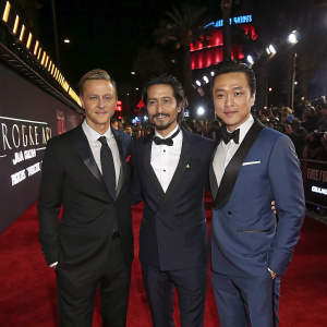 Alan Tudyk, Diego Luna, and Donnie Yen at the premiere of Star Wars: Rogue One. Glowing red carpet and flashing cameras.