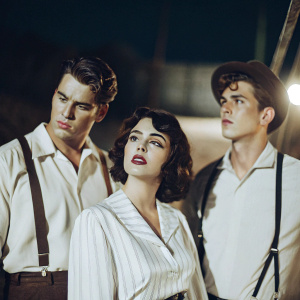 Promotional image for 'Giant'. Dark themed. Features Rock Hudson, James Dean, Elizabeth Taylor.