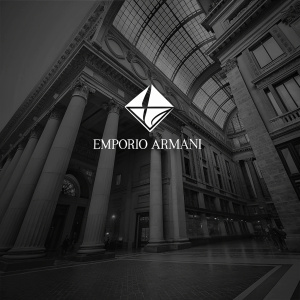 A sleek and modern logo design for Armani. Clean black background. Classic elegant font spelling out EMPORIO ARMANI. Unique white geometric shape at the top.