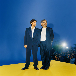 Diego Luna and Steven Spielberg at Cannes Film Festival premiere. Wearing black suit and white shirt. Crowded venue