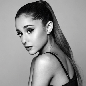 Ariana Grande on the cover of a magazine. Striking pose with intense gaze. Bold black and white photo shoot