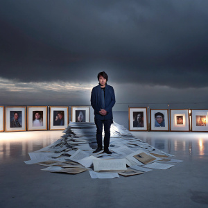 Daniel Padilla, a rising Asian actor, amidst an array of candid photos and scripts. Displayed at career retrospective exhibition.