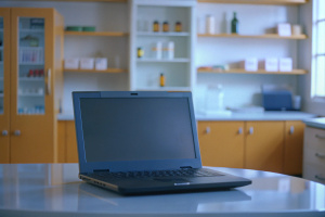1999 toshiba laptop on a table in a white room, in pharmacy, in ethiopia