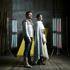 Oscar Isaac and Gugu Mbatha-Raw, standing on a vibrant yellow set. Variety Studio backdrop with neon lights behind them.
