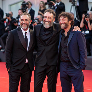 Antonio Manetti, Marco Manetti, and Valerio Mastandrea at the Venice Film Festival. Red carpet event, celebrating 'Diabolik - Ginko all'attacco!'. Festive atmosphere, smiling for photographers.