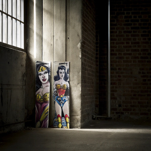 Designing a DC Comics Tattoo Pack packaging. Featuring colorful and dynamic tattoo designs inspired by classic comic book characters such as Wonder Woman, The Joker, and more. The packaging mimics comic book art with vibrant colors and intricate lines, making it visually appealing and informative.