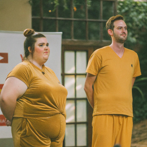 Christine Sydelko, a plus-sized woman with a bun, wearing a Texas-themed t-shirt, and Elijah Daniel, a Caucasian man with a close-cropped haircut, stand confidently at a GLSEN YouTube event. White backdrop, GLSEN and YouTube logos visible.