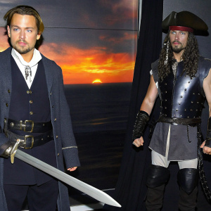 A dynamic digital art collage featuring Johnny Depp as Captain Jack Sparrow alongside a gladiator figure, set against a vibrant sunset backdrop. Elements from the 'King Arthur' film poster and a sleek, stylized sword are intricately integrated, merging photo-realism with fantasy art.