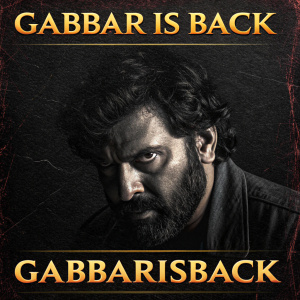 Promotional poster for Gabbar is Back. Dark and dramatic design with rich tones. Textured black background. Close-up of a face at the center. Hashtag GabbarisBack at bottom.