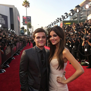 Josh Hutcherson and Victoria Justice, at the MTV Movie Awards. The red carpet is crowded with paparazzi and fans.