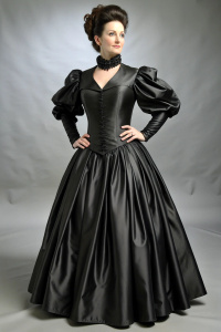 Period correct 40 yo attractive Victorian brunette in shiny black satin dress, very narrow waist and massive prominent bosom. long puff sleeves, floor length big skirt with petticoat.   by  dinner table