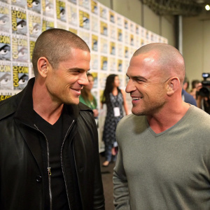 Wentworth Miller and Dominic Purcell in a candid backstage photo at a Comic-Con event. Miller dons a sleek black jacket, Purcell in a more relaxed outfit.