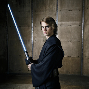 Young actor in serious pose for Star Wars promotional photo. Gray backdrop, dark green eye makeup