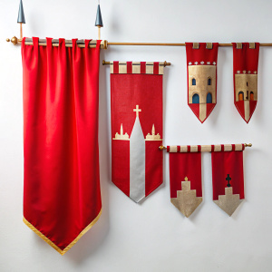 Red medieval battle flag. Hanging fabric royal banner, pennant mockup and castle wall flagsisolated on white background
