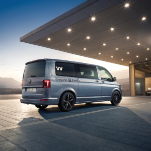 Advanced CGI image showcasing a new VW Transporter T6 Kombi Van. Sleek design, streamlined body, prominent VW logo on rear panel.