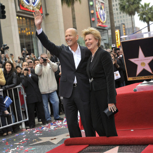 Bruce Willis and Marlene Willis celebrating at their star unveiling ceremony on Hollywood Boulevard. Crowd cheering in background.