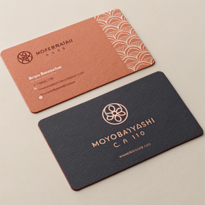 Business cards for Motobayashi Co Ltd. Two cards, one with a warm terracotta shade, the other with a darker muted tone. Both feature a logo, website info. Modern, elegant design with clean lines, balanced layout.