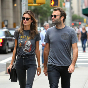 Alessandra Ambrosio and Jamie Mazur walking down a busy city street. Alessandra in a graphic t-shirt and sunglasses, Jamie in a gray t-shirt. Both in casual attire.