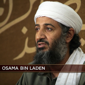 Close-up of Osama Bin Laden in traditional white headwear and beard, serious expression. Screen-shot style image with muted brown background and Arabic text