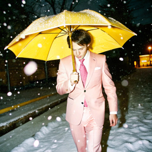 suit and tie, pink, in heavy snow, umbrella