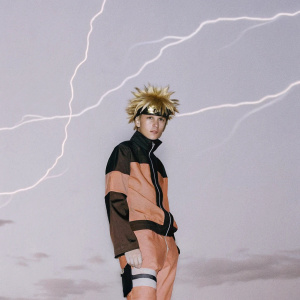 Naruto Uzumaki, a young ninja with spiky blonde hair, stands in a heroic pose. Wearing an orange and black outfit. Dynamic energy swirls around him. Dark blue sky backdrop.