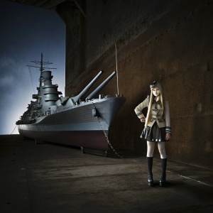 Digital artwork featuring an anthropomorphic representation of USS Iowa from Kantai Collection. A confident young anime girl with long blonde hair, wearing a military-themed outfit, stands beside the detailed 3D model of the warship. Set against a dramatic dark blue backdrop.