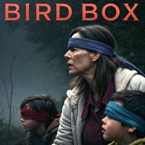 A promotional poster for the Netflix film 'Bird Box', featuring Sandra Bullock and other characters wearing blindfolds. Dark and suspenseful atmosphere