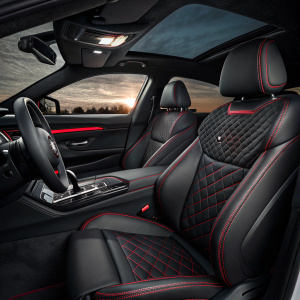 Inside a new BMW M4, leather seats, black and red stitching, luxury ambiance, dimly lit, sporty